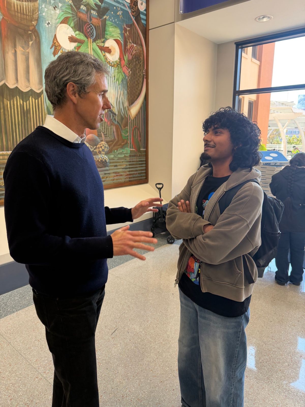 Beto speaking with a student.