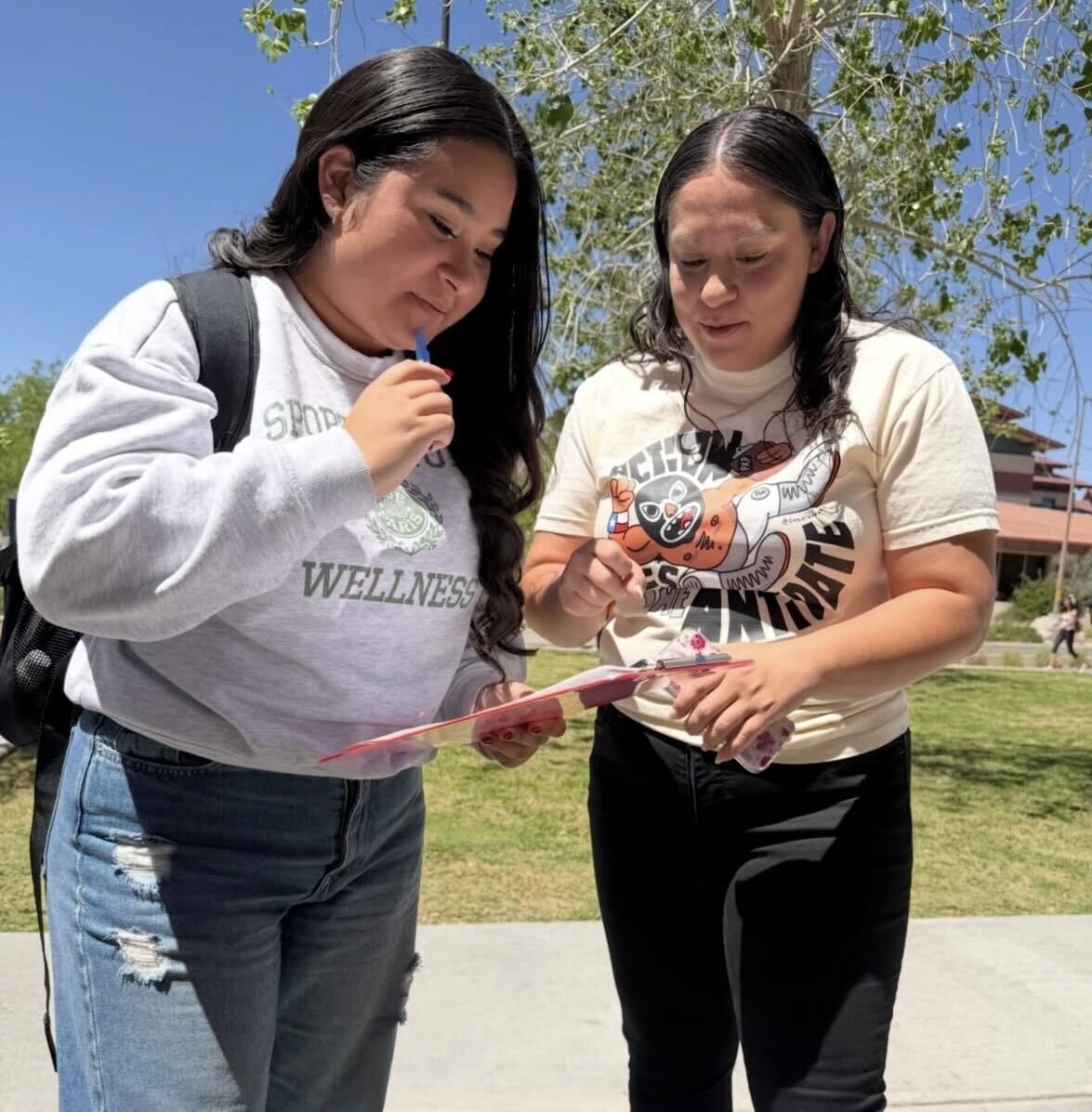 A Powered by People volunteer helping someone register to vote.