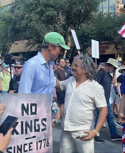 Beto speaking to an attendee at a No Kings rally.